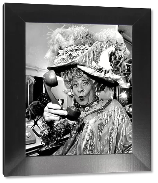 Stanley Baxter, dressed as a pantomime dame