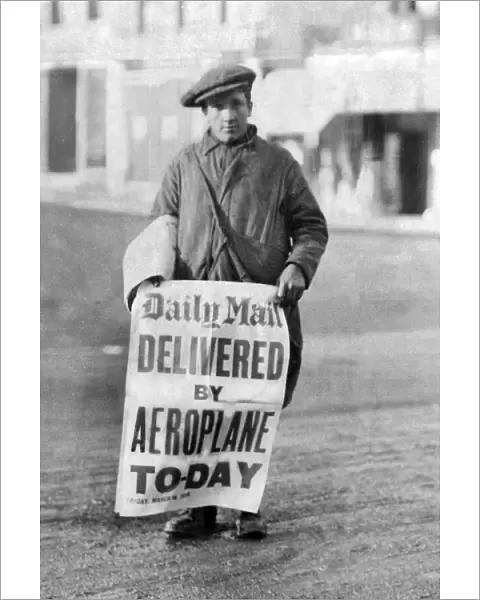 A newspaper boy with a sign