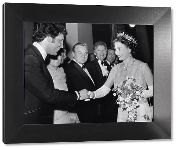 Queen Elizabeth II is presented to singer Tom Jones