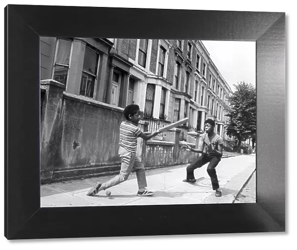 Boys playing cricket in the street 1973