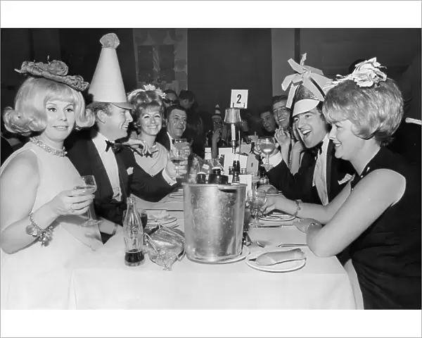 Bobby Moore, and wife Tina Moore across the table from Terry Venables and his wife 1967 at a New Years Party