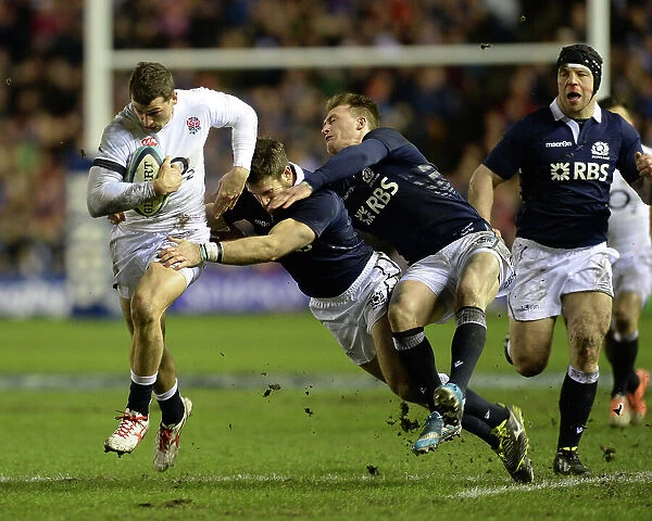 England's Jonny May runs with the ball as he evades a tackle