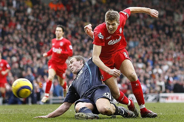 Liverpool's Steve Gerrard is tackled by Manchester City's Richard Dunne