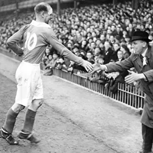 A Charlton supporter dashes out to shake hands with Don Welsh