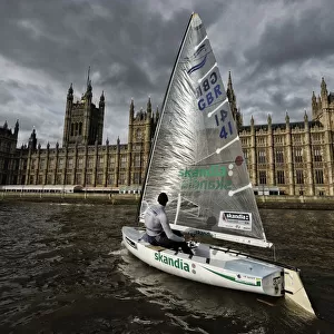 Finn class dinghy on the Thames by the Houses of Parliament