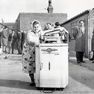 Mrs. Sarah Dewhirst taking away the washing machine from the Peel Park ground at Accrington Stanley, 1962