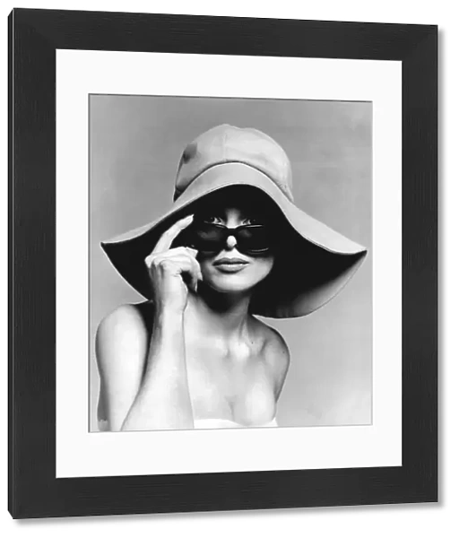 Model wearing floppy hat and sunglasses