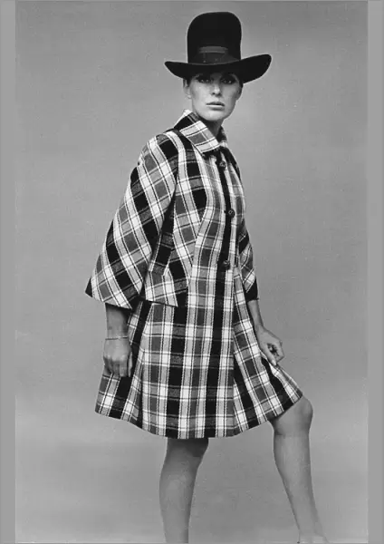 Model wearing large hat and checked coat