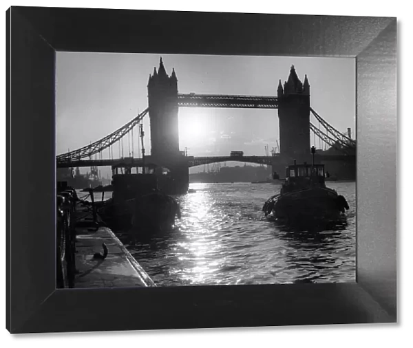 Tower Bridge, London silhouetted with sun behind, 1962