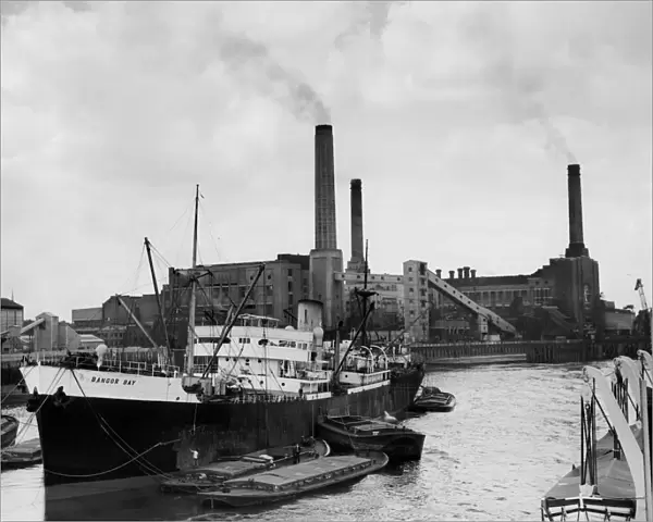 Deptford Power Station seen from the river with cargo steamer B