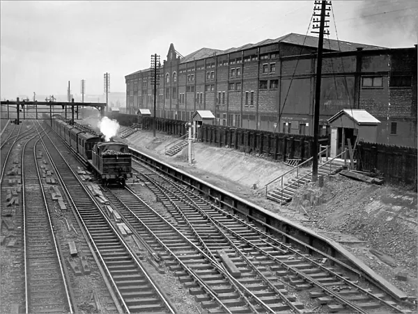 Train passing Manchester United Football Ground, 1935