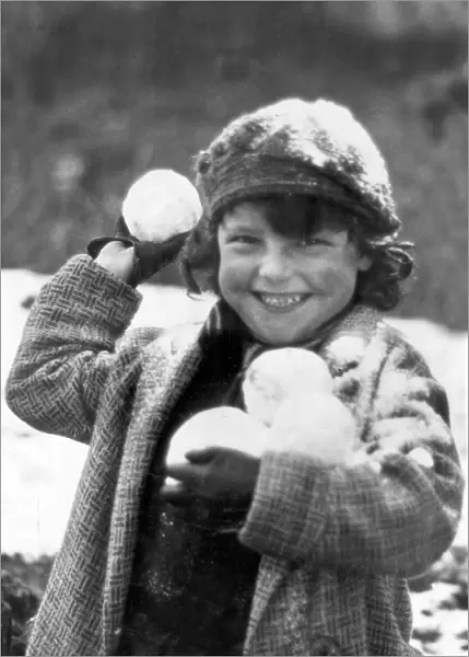 Snowball. A small child, wrapped up against the cold in Penrhos