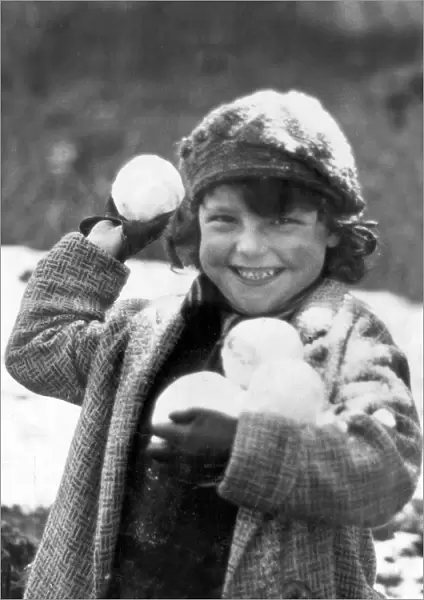 Snowball. A small child, wrapped up against the cold in Penrhos