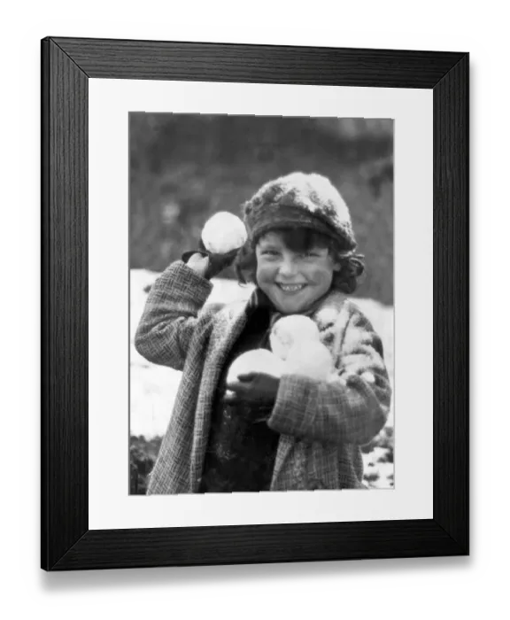 Framed Print : Snowball. A small child, wrapped up against the cold in Penrhos Framed Print : Snowball. A small child, wrapped up against the cold in Penrhos