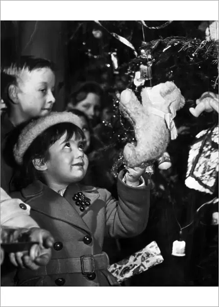 Putting presents on the tree, 1950s