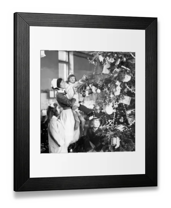 Framed Print : Decorating a Christmas tree 1922 Framed Print : Decorating a Christmas tree 1922