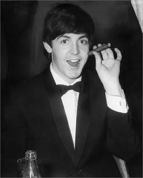 Paul McCartney smokes a havana cigar at The Empire, Leicester Sq