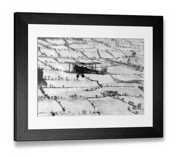 Framed Print : A Tiger Moth over snow-covered countryside, 1927 Framed Print : A Tiger Moth over snow-covered countryside, 1927