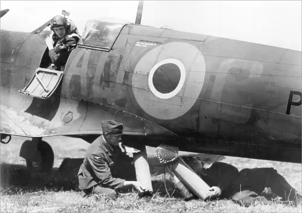 RAF ground crew loading air sea rescue equipment into the belly of a Spitfire
