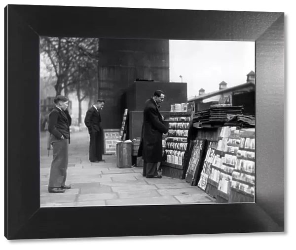 Street trader selling postcards, Embankment, 1946