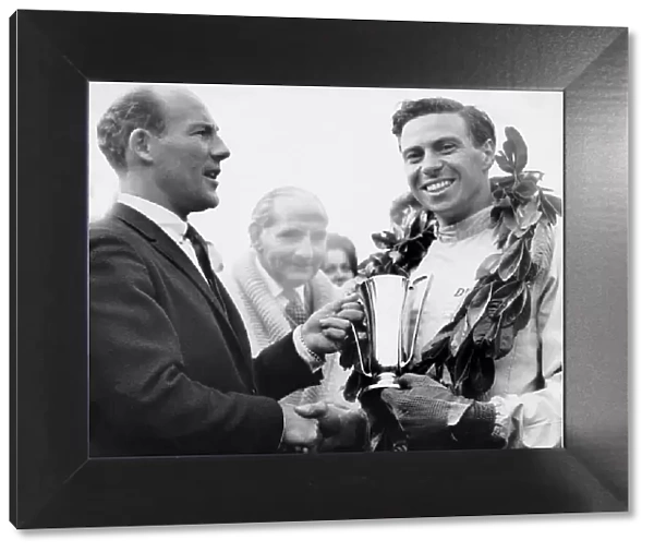 Jim Clark accepts the trophy from Sir Stirling Moss 1962