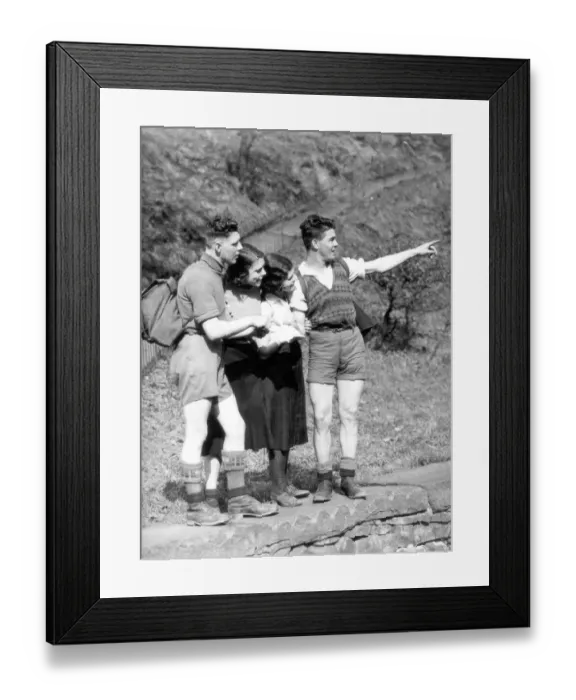 Framed Print : Hikers studying a map