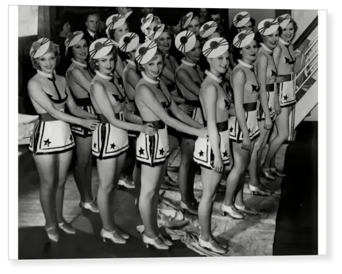 Print : CB Cochran dancers in costume on stage for production of musical