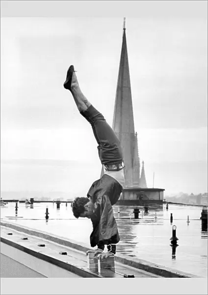 Handstand. Sebastian, a Bertram Mills high-wire act, on the roof of the Royal Garden Hotel