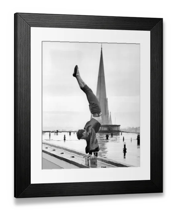 Framed Print : Handstand. Sebastian, a Bertram Mills high-wire act, on the roof of the Royal Garden Hotel Framed Print : Handstand. Sebastian, a Bertram Mills high-wire act, on the roof of the Royal Garden Hotel
