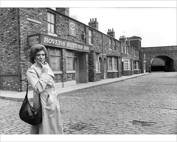 Pat Phoenix stands outside the Rovers Return in Coronation Street