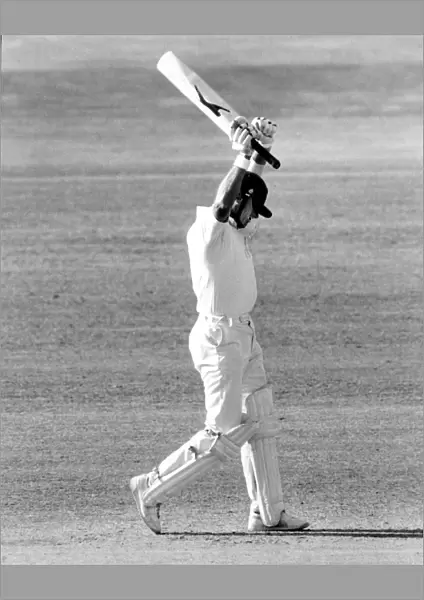 Geoff Boycott raises both arms to celebrate a Test century