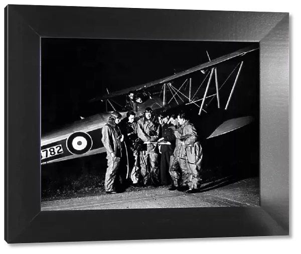 RAF Pilots look at their maps before taking off at Biggin Hill on exercises