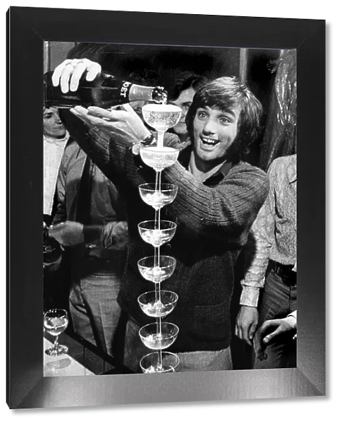 George Best pouring champagne