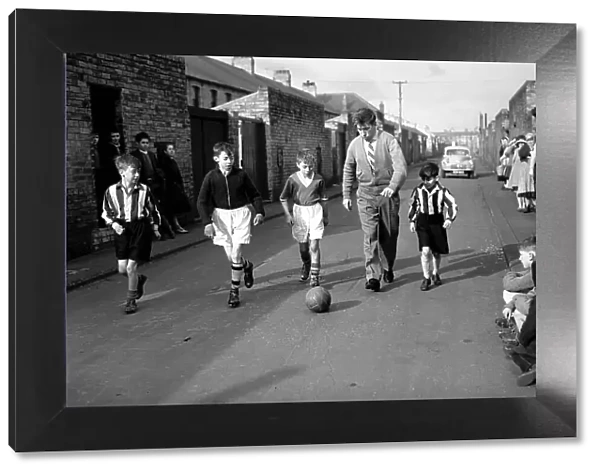 Bobby Charlton plays football with children in his home town of Ashington