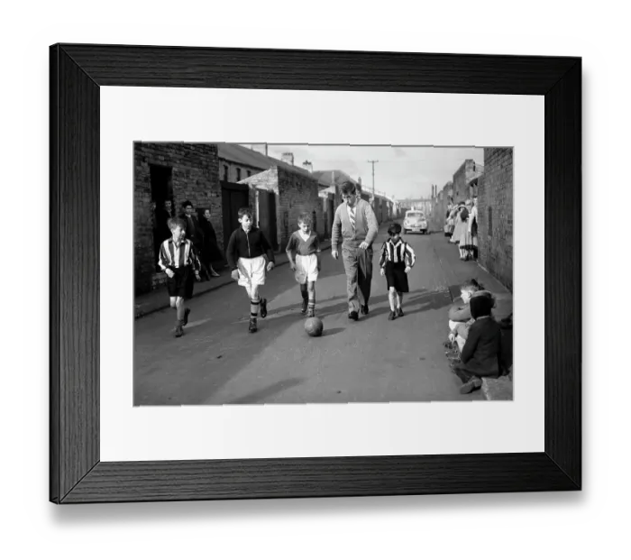 Framed Print : Bobby Charlton plays football with children in his home town of Ashington Framed Print : Bobby Charlton plays football with children in his home town of Ashington