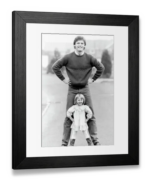 Framed Print : Gordon McQueen, former Manchester United footballer and television pundit is pictured with his daughter Hayley McQueen in 1983 Framed Print : Gordon McQueen, former Manchester United footballer and television pundit is pictured with his daughter Hayley McQueen in 1983