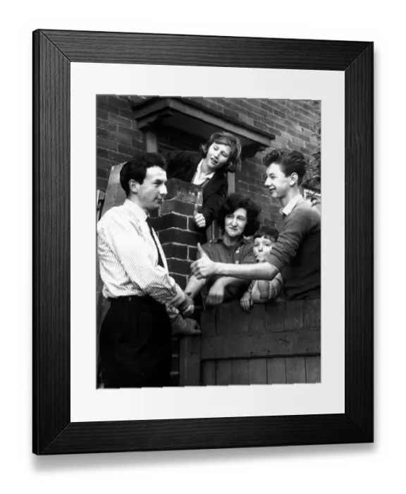 Framed Print : Huddersfield footballer Mike O'Grady is congratulated by neighbours at his Leeds home after being capped for England Framed Print : Huddersfield footballer Mike O'Grady is congratulated by neighbours at his Leeds home after being capped for England