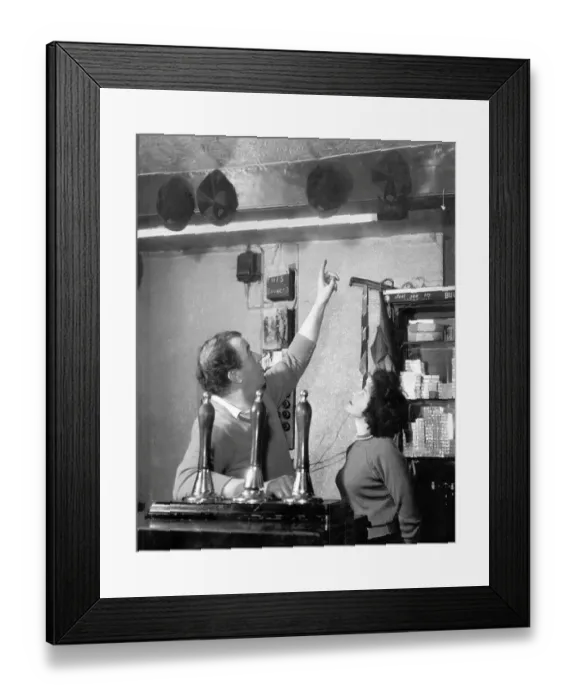 Framed Print : Dixie Dean shows off his England caps at the Dublin Packet pub in Chester, where he was landlord