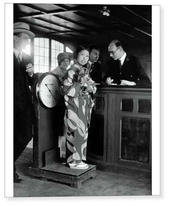 Print : Miki, the Japanese artiste, standing with her dog on the scales at Le Bourget Airport, Paris 1928