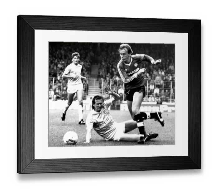 Framed Print : Peter Barnes of Manchester United (Ex City) beats John Gidman of City (Ex United) Framed Print : Peter Barnes of Manchester United (Ex City) beats John Gidman of City (Ex United)