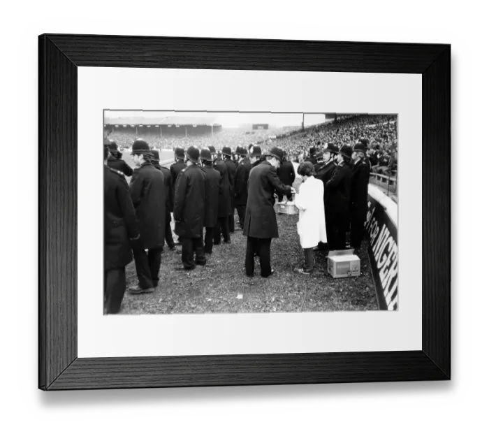 Framed Print : A police officer buys snacks from a vendor during the 1982 FA Cup quarter-final at Stamford Bridge Framed Print : A police officer buys snacks from a vendor during the 1982 FA Cup quarter-final at Stamford Bridge