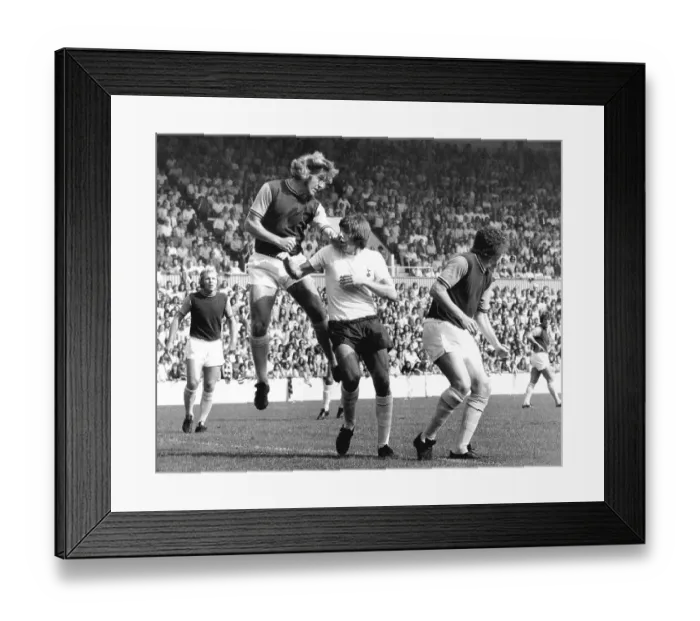Framed Print : West Ham's Bobby Moore watches his team mate Tommy Taylor head the ball away from Tottenham's Martin Peters Framed Print : West Ham's Bobby Moore watches his team mate Tommy Taylor head the ball away from Tottenham's Martin Peters