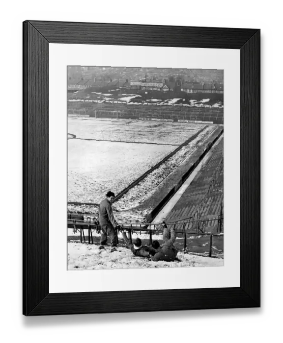 Framed Print : Crystal Palace footballers sliding down the snowy slope at the Selhurst Park ground