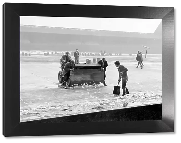 Groundsmen attempting to rid the pitch of ice at Anfield, during the bad winter of 1962 / 1963