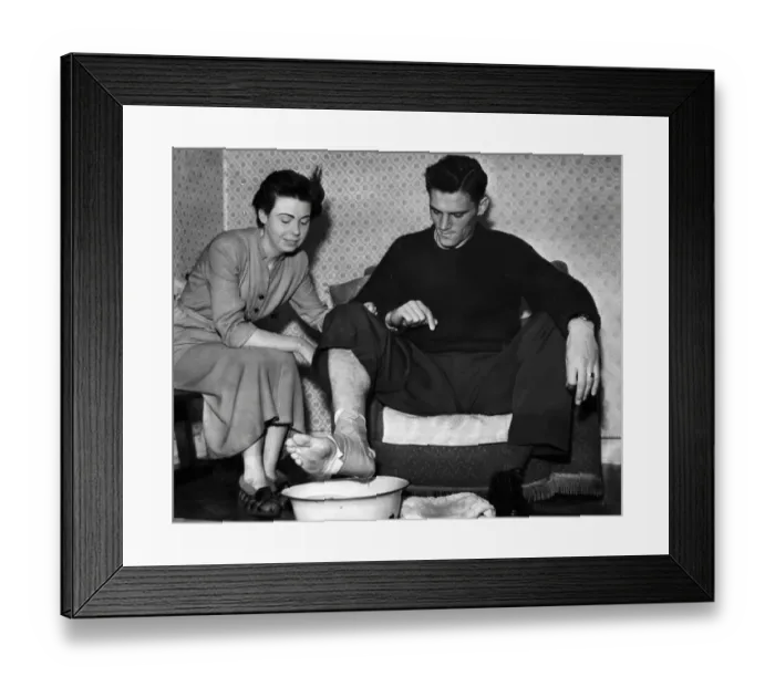 Framed Print : Manchester City footballer Bill Leivers soaking his injured foot in a bowl of water prepared by his wife, Shirley Framed Print : Manchester City footballer Bill Leivers soaking his injured foot in a bowl of water prepared by his wife, Shirley