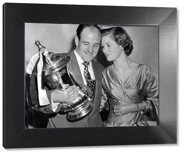 Jimmy Scoular and wife Joyce admiring the FA Cup trophy after Newcastle United victory in 1955