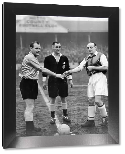 Notts County captain Tommy Deans, referee J.W. Topliss and Sheffield Wednesday captain Eddie Gannon during FA 4th round replay 1955