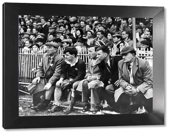 Rugby International 1961. Injured Cyril Davies sits on the touchline bench as Wales battle to victory