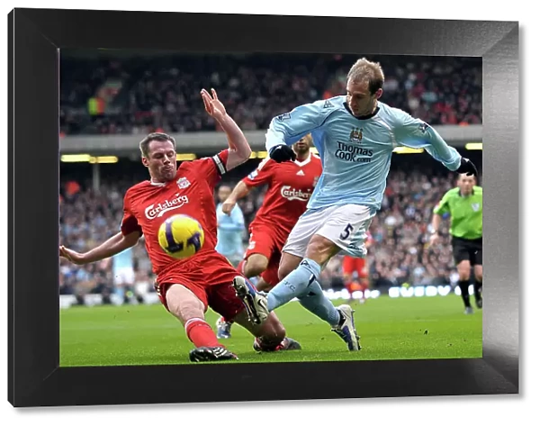 Liverpool's Jamie Carragher tackles Manchester City's Pablo Zabaleta