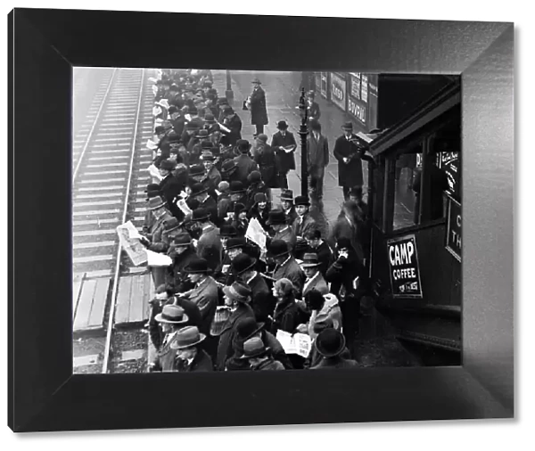 Crowd of commuters on rail platform at Ilford station, 1930